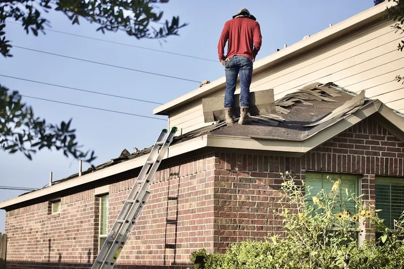 Professional roofer working on a residential roof in Westover